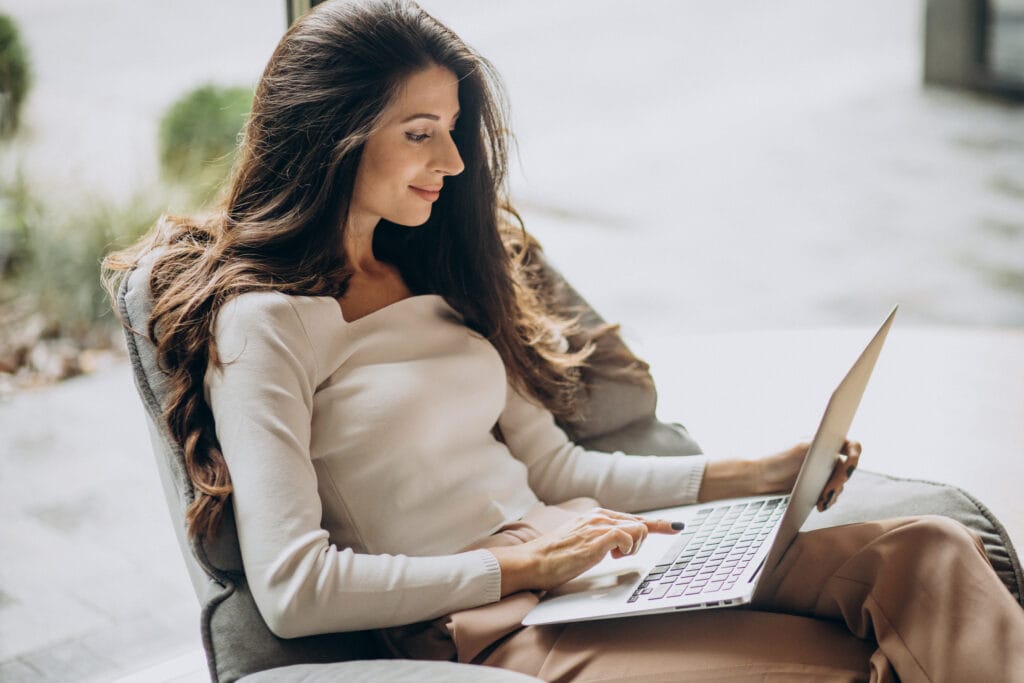 Young business woman sitting cahir working computer 1024x683